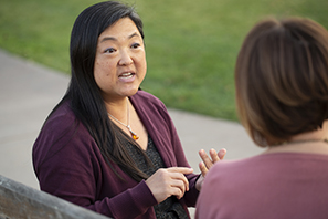 Kathy Kim talking with a colleague